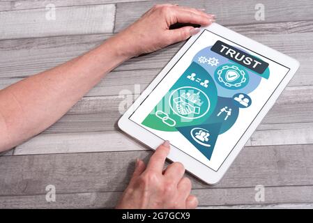 Trust concept shown on a tablet used by a woman Stock Photo