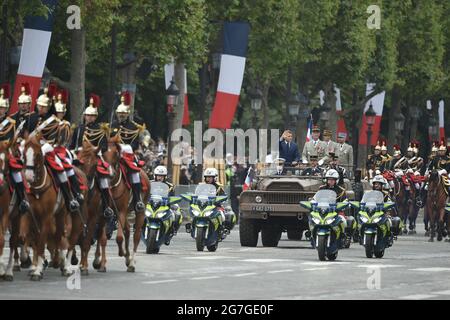 Paris, France, July 14, 2021. French President Emmanuel Macron and French Armies Chief of Staff General Francois Lecointre stand in the command car as they review troops prior to the annual Bastille Day military parade on the Champs-Elysees avenue in Paris on July 14, 2021. Photo by Eliot Blondet/ABACAPRESS.COM Stock Photo