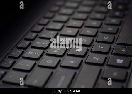 Closeup of a black laptop QWERTY keyboard Stock Photo