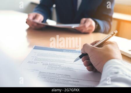 Executive reading a resume during a job interview and businessman Completing Application Form. Hiring concept. Stock Photo