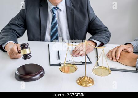 Male lawyer or Counselor working in courtroom have meeting with client are consultation with contract papers of real estate, Law and Legal services co Stock Photo