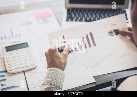Business Financing Accounting Banking Concept, businessman doing finances and calculate about cost to real estate investment and in other, tax system. Stock Photo