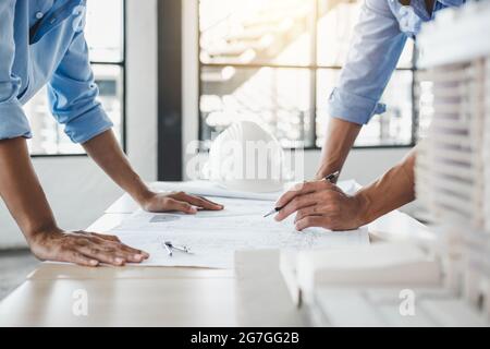 Construction concept of Engineer or architect meeting for project working with partner and engineering tools on model building and blueprint in workin Stock Photo
