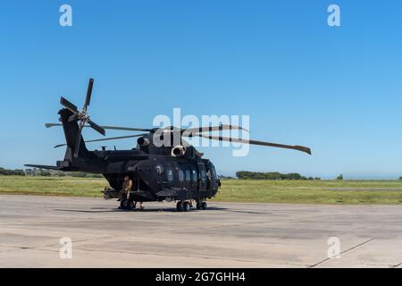 A modern American military helicopter, ready to fly for a tactical operation, is on the runway. Stock Photo