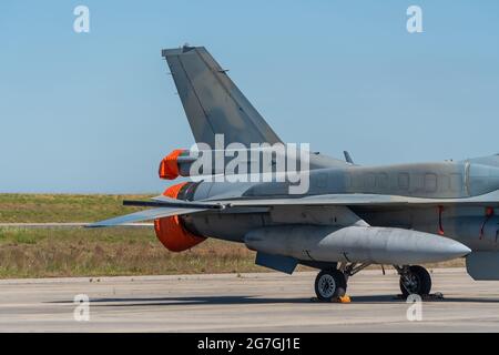 A modern American military aircraft, with a missile bomb on the wing, for launching attacks. Parked at the airport. Stock Photo