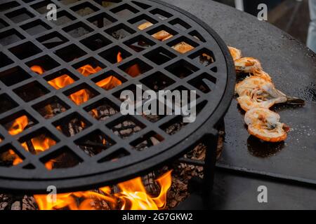 Process of grilling red prawns on brazier with hot flame - close up Stock Photo