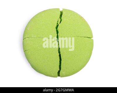 One green macaroon isolated on white background, colorful french cookies macarons. Broken cookie with crumbs Stock Photo
