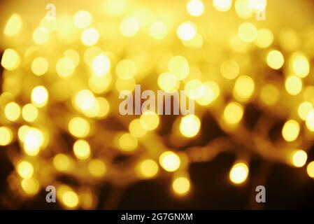 Golden colored blurred background. Abstract background with bokeh. Stock Photo
