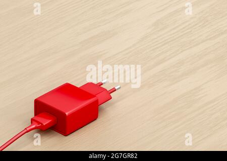 Smartphone, tablet or other electronic device charger on the wooden table Stock Photo