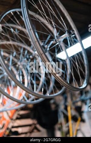 Fixated Bike Rims Metal shiny bike rims hanging on rack in repair service Stock Photo - Alamy