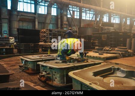 Construction of the building. Workers unrecognizable make metal ...
