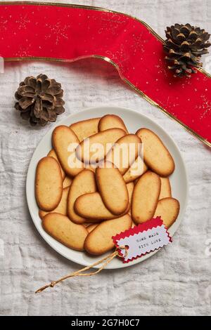 Top view of pile of delicious Christmas cookies placed on plate on tablecloth for holiday celebration Stock Photo