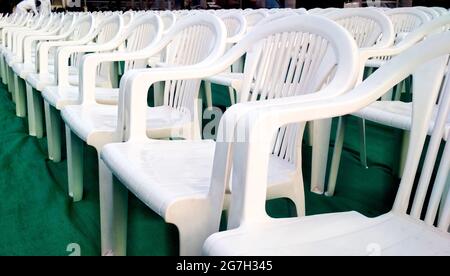 Rows of empty white chairs waiting for the audience in india Stock Photo