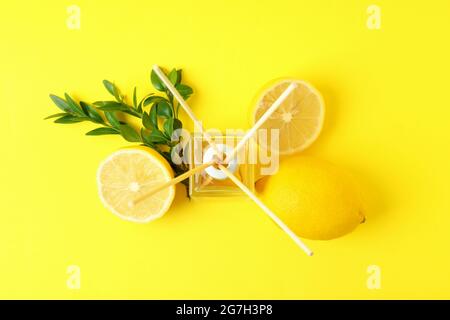 Diffuser, lemons and leaves on yellow background Stock Photo