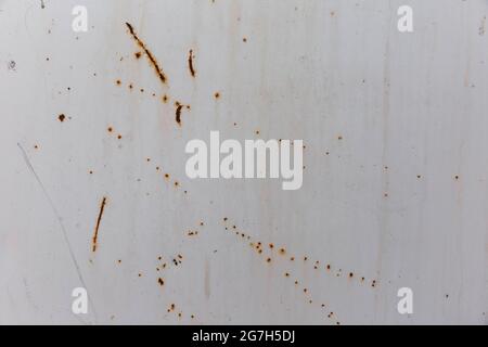 Corroded metal background. Rusted grey painted metal wall. Rusty metal background with streaks of rust. Rust stains. The metal surface rusted spots. R Stock Photo