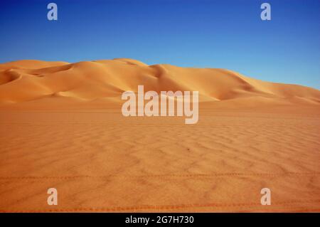 Golden coloured sand dunes in the Ubari Sand Sea, Sahara Desert, Libya. Stock Photo