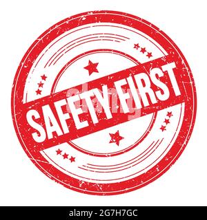 SAFETY FIRST text on red round grungy texture stamp. Stock Photo