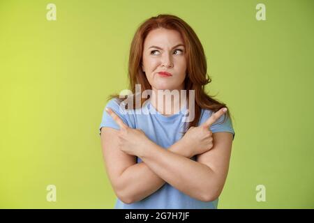 Time make right choice. Perplexed hesitant redhead middle-aged female ...
