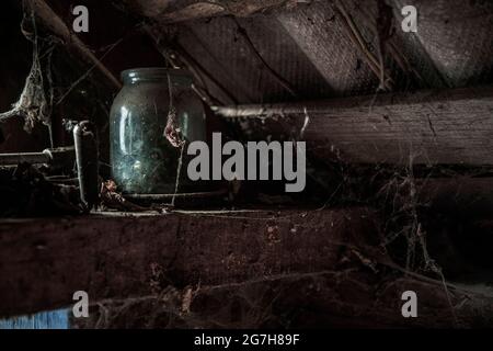 dusty glass with cobwebs in an old abandoned house Stock Photo