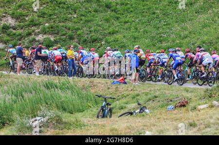 Col de Iseran, France - July 26, 2019: The Peloton climbing the road to Col de Iseran during the stage 19 of Le Tour de France 2019. Stock Photo