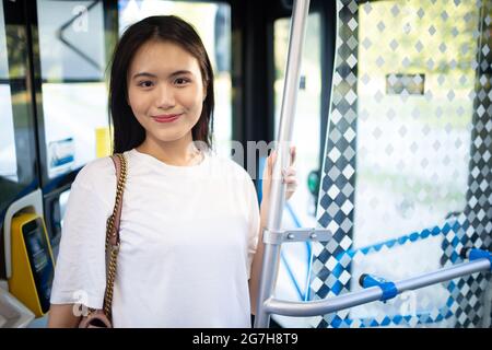Asian Woman take a ride in public transport bus or tram Stock Photo - Alamy