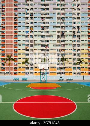 colorful basketball court and rainbow colored building facade in Hong Kong Stock Photo