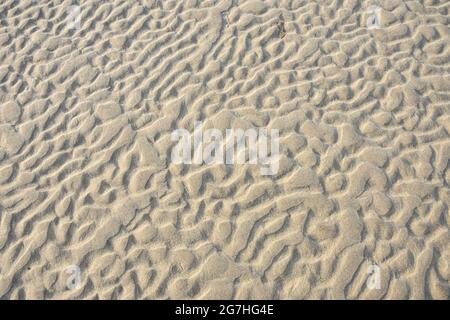 Shapes in the sand exposed at low tide that were formed by water movement over sandbars.  West Meadow Beach, Stony Brook, New York Stock Photo