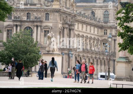 Random people at the gardens of The Louvre, or the Louvre Museum, is the world's largest art museum and a historic monument in Paris, France Stock Photo