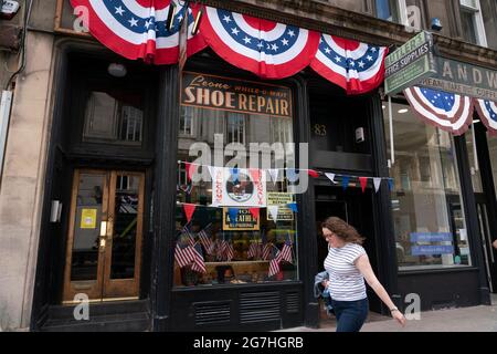 Glasgow, Scotland, UK. 14 July  2021. Filming begins on location in Glasgow city centre for the latest Indiana Jones movie. Filming was taking place on Cochrane Street and final touches were being made to shopfronts on St Vincent Street to convert them into period American stores.  Iain Masterton/Alamy Live news. Stock Photo