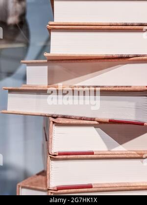 High books stack isolated on blurred background.forefront of a group of books stacked.Old books on shelf in the Library Stock Photo