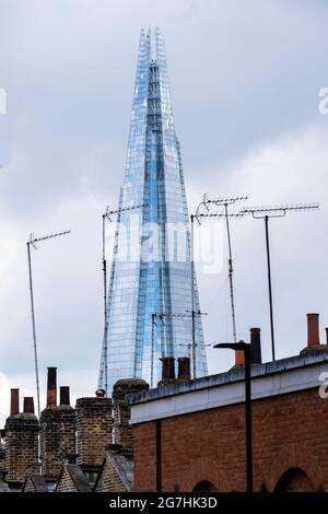 The Shard tower appears as a landmark seen from Waterloo looking through the chimney pots and TV aerials in Roupell Street Stock Photo