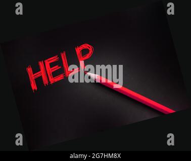Help word writing on black paper and yellow pencil. Business or healthcare concept Stock Photo
