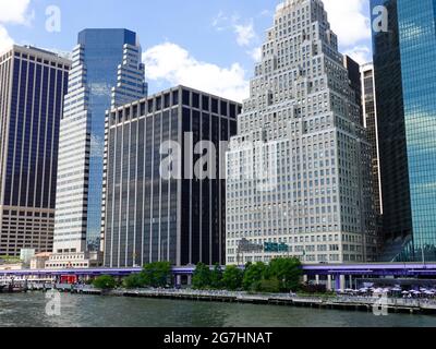 Financial District skyscrapers provide a backdrop for the FDR Parkway along the East River in Lower Manhattan, New York, NY, USA. Stock Photo