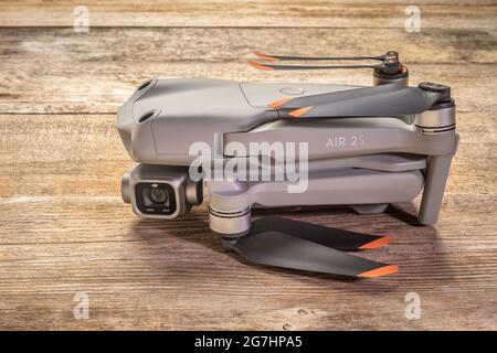 Fort Collins, CO, USA - July 4, 2021: DJI Mavic Air 2s drone in a folded position against rustic wood, an advanced prosumer folding drone. Stock Photo