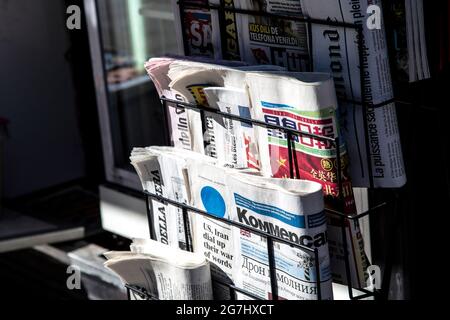 Rack of foreign language newspapers at a newsagent stand in Soho, London, UK Stock Photo