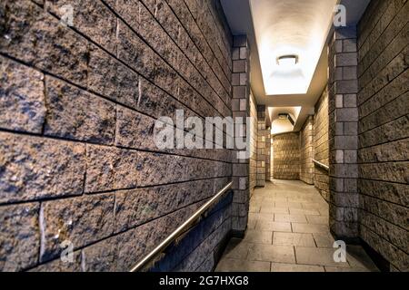 Passageway through a building built in the 1980s, Hartshorn Alley, City of London, UK Stock Photo