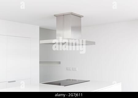 Cooker hood and electric stove of a modern and minimalist kitchen Stock Photo