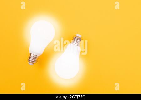 A Power Saving Lamps on Yellow Background - Top View Stock Photo