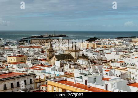 Cadiz, Andalusia, Spain. Aerial panoramic view from Tavira tower of old city with narrow winding alleys, rooftops and seashore on sunny day.Europe Stock Photo