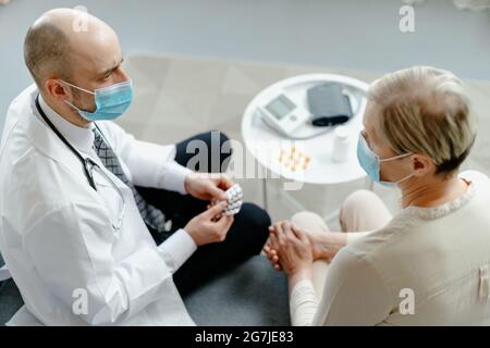 home doctor explains to the patient the rules for taking medications . Stock Photo