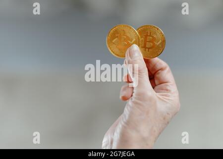 close-up. two bitcoins in the hands of a business woman. Stock Photo