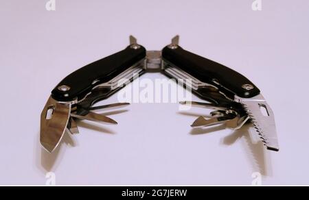 Black multitool on a white background Stock Photo