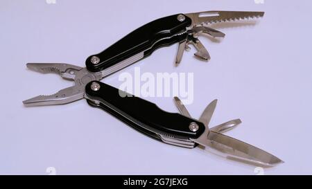 Black multitool on a white background side view Stock Photo