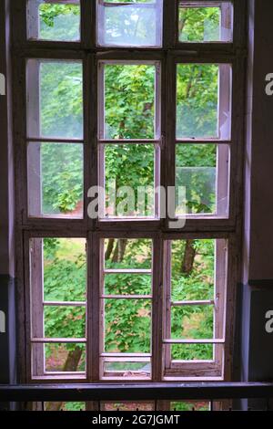 stained glass window with broken glass in an abandoned building Stock Photo