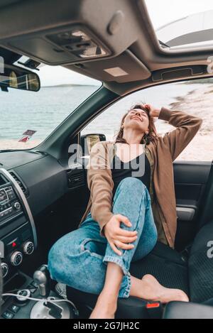 Young Woman Poses For A Photograph Near A Car High-Res Stock Photo - Getty  Images