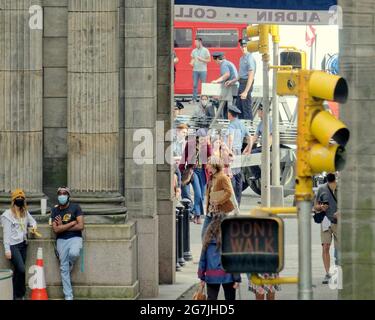 Glasgow, Scotland, UK,  14th  July, 2021.Indiana jones filming started today as traffic restrictions start from  in the city centre and the shop fronts and decorations are finished as locals awaited the arrival of Harrison ford Phoebe Waller-Bridge and indiana jones appeared in a 1960s flower power type crowd scene type equal rights welcoming home the apollo astronauts. Credit Gerard Ferry/Alamy Live News. Stock Photo