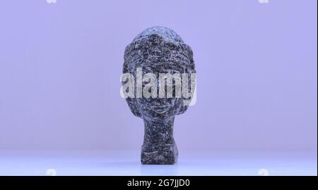 figurine-portrait of a female head made of stone in full face Stock Photo