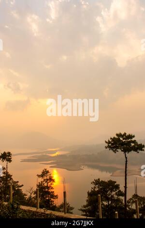 Sunset at Umiam Lake is a reservoir in the hills north of Shillong Stock Photo