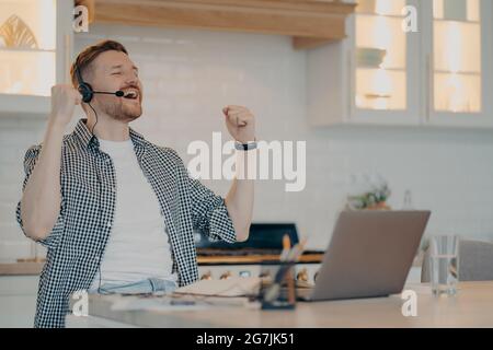 Joyful male worker feeling excited and enjoying success Stock Photo