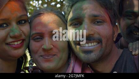 Closeup of happy young Indian friends with colored faces during the festival of Holi, India Stock Photo